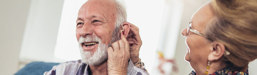 Older man and woman or pensioners with a hearing problem